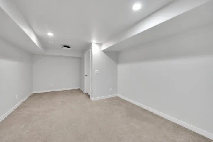 Carpeted room featuring recessed lighting, a ceiling-mounted light fixture, white walls, and white trim