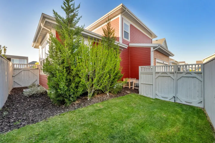 Manicured lawn area with a privacy fence and garden gate