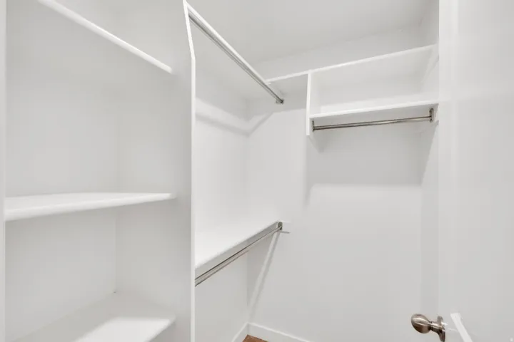 White closet system featuring multiple shelving units and hanging rods