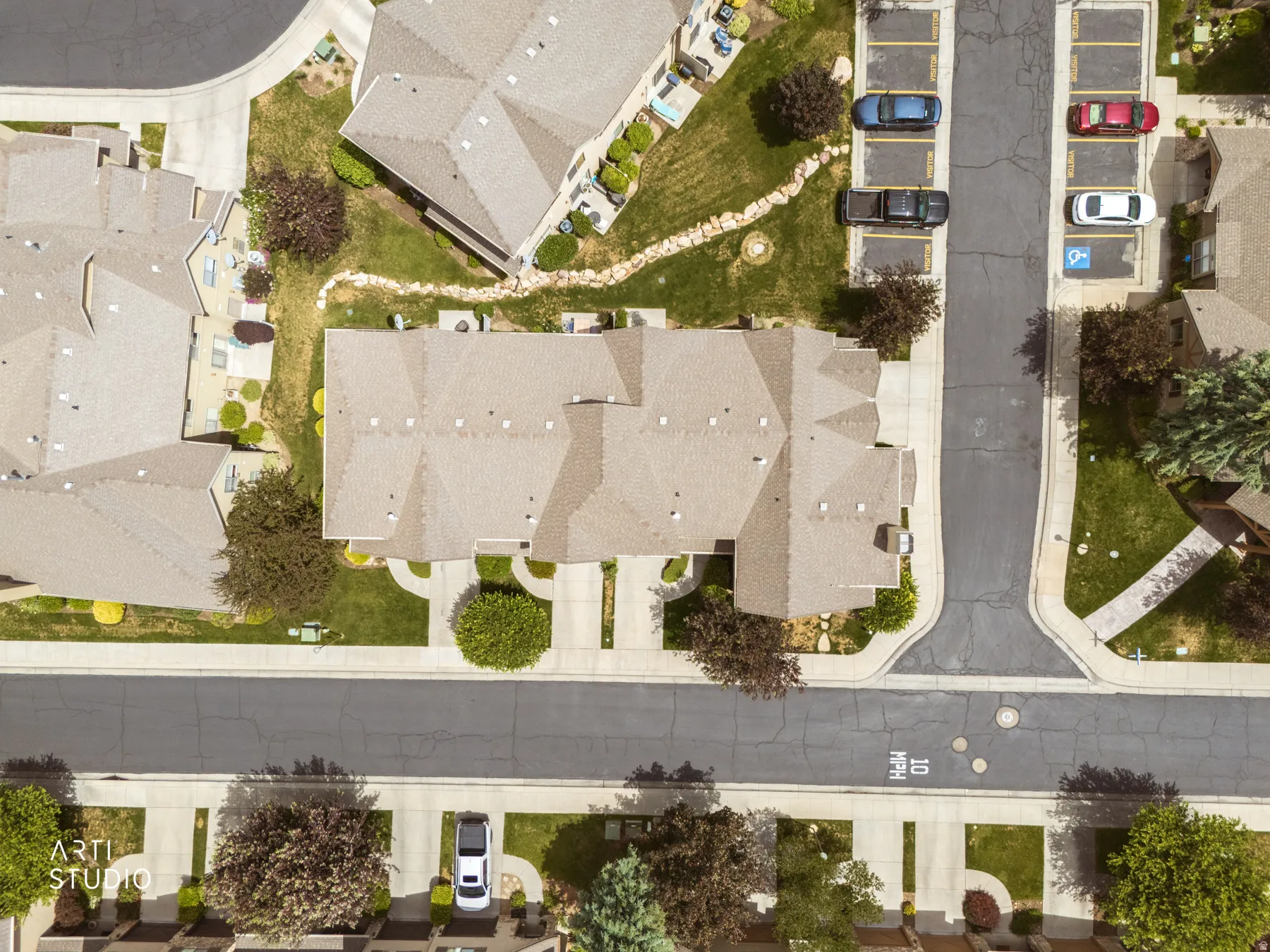 Aerial perspective showcasing multiple properties with uniform rooflines
