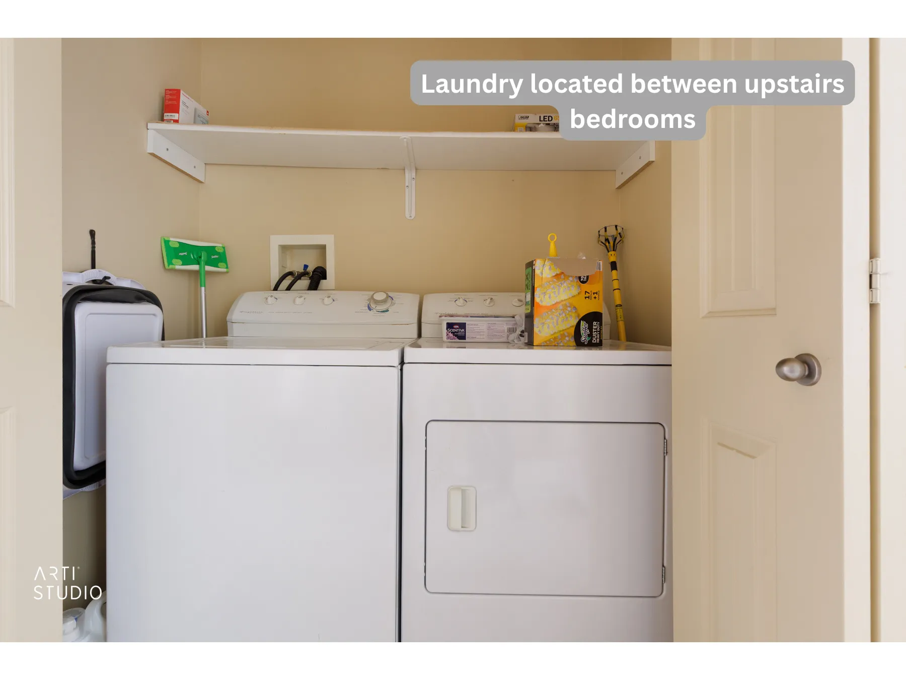 Dedicated laundry area featuring a built-in white shelf and neutral wall finishes