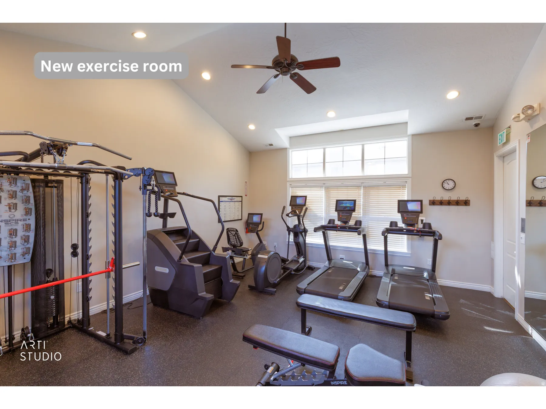 Spacious exercise room featuring a vaulted ceiling, recessed lighting, ceiling fan, and large windows with blinds