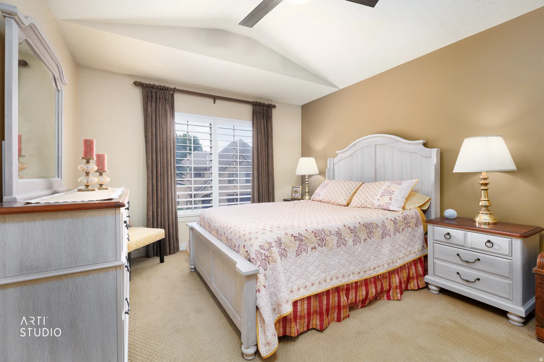 Bedroom featuring vaulted ceilings and neutral carpeting
