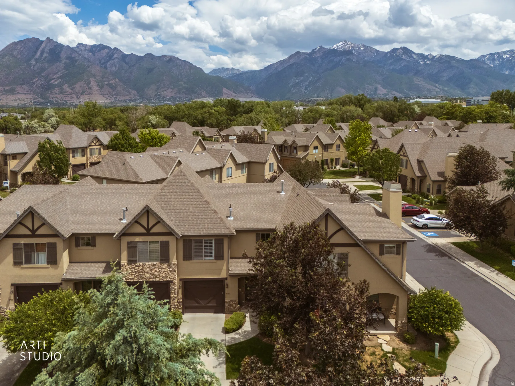 Residential community featuring stucco exteriors, pitched roofs, and mature landscaping