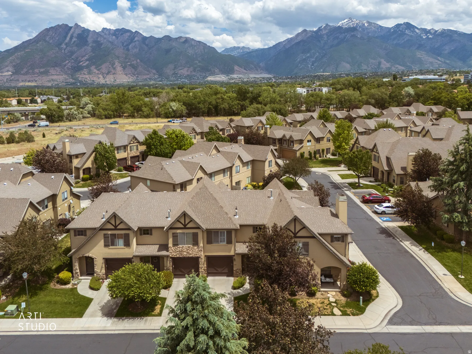 Community of residential properties set against a mountainous backdrop