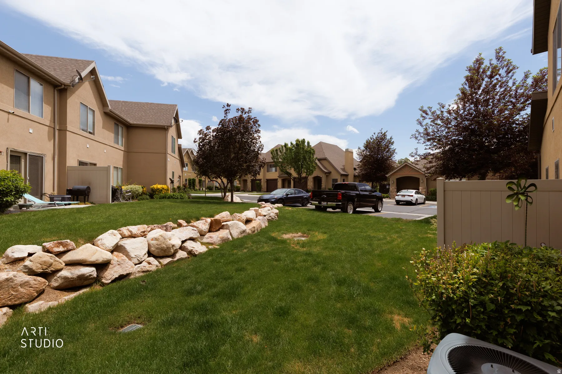 Expansive green space featuring a decorative rock border and manicured lawn