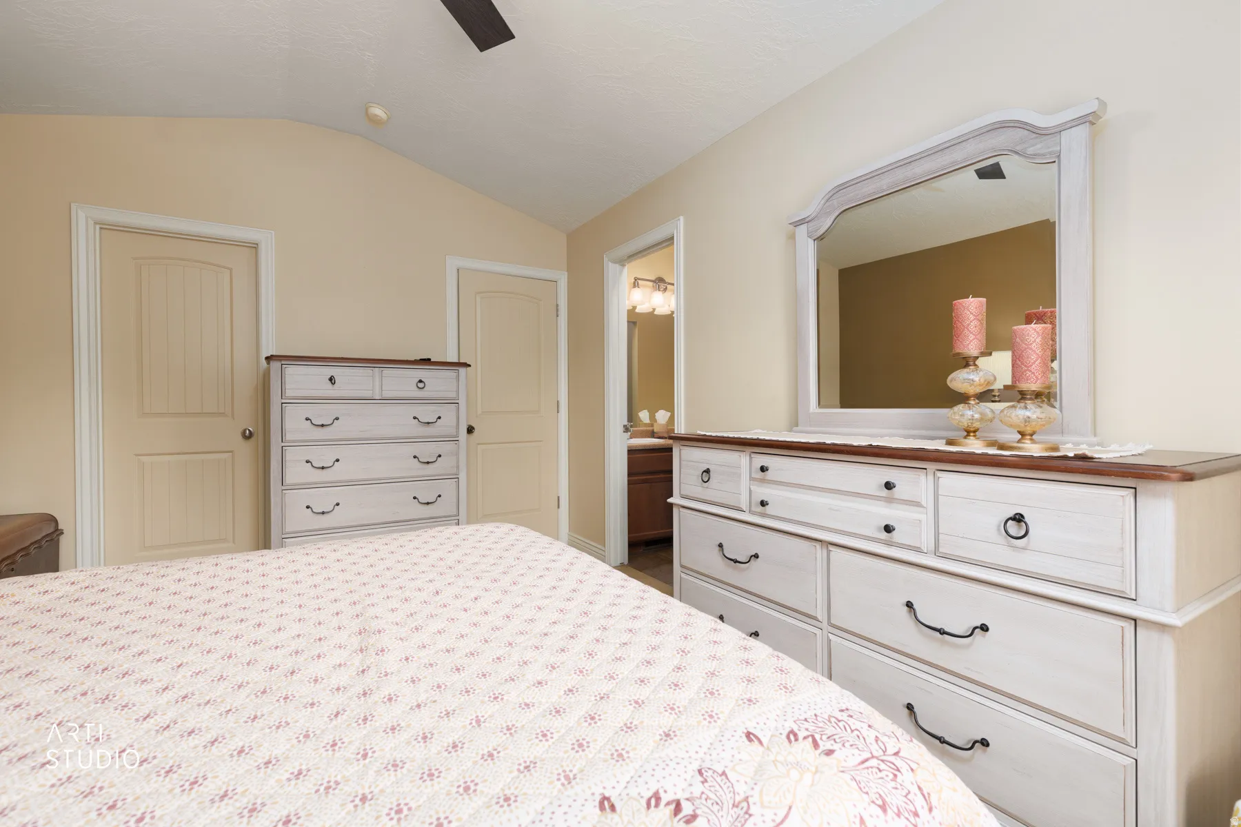 Vaulted ceiling bedroom with neutral wall tones and panel doors
