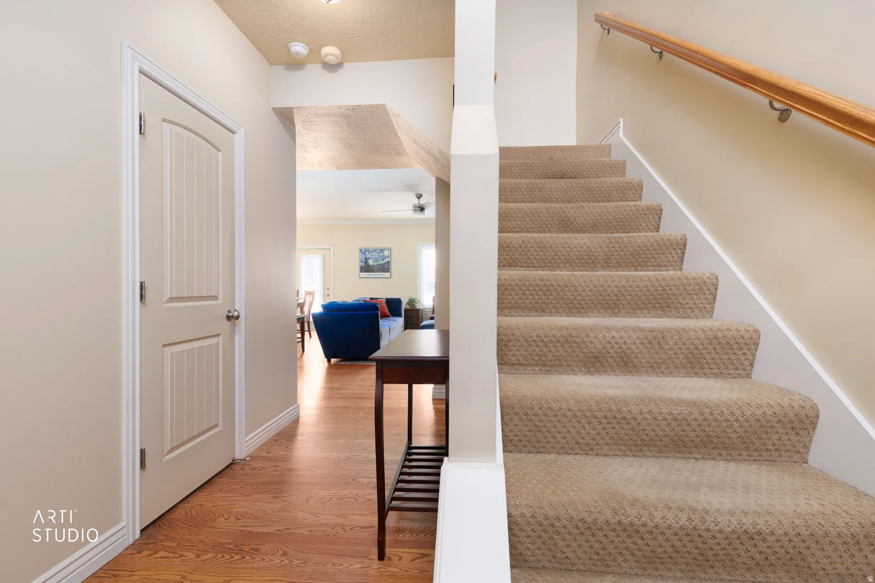 Entryway featuring wood-finish flooring, white baseboards, and a paneled door