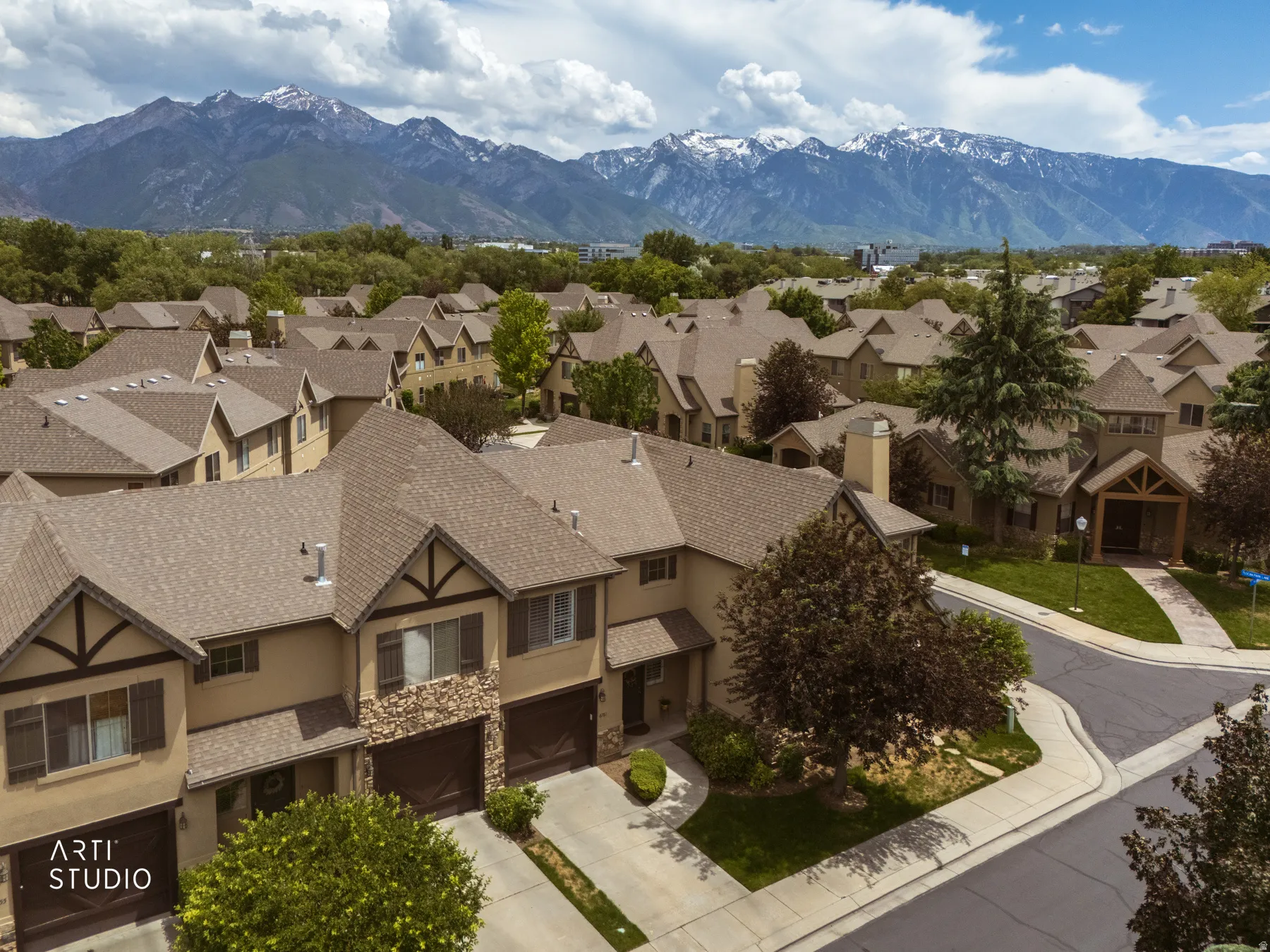 Aerial perspective showcasing a residential community with snow-capped mountain scenery