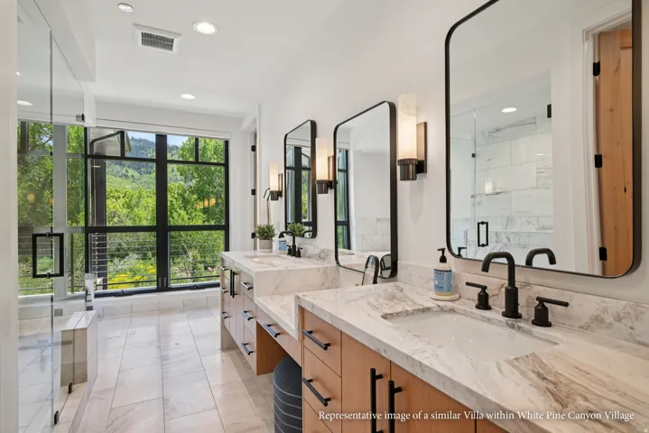 Dual vanity with stone countertops and undermount sinks, matte black fixtures, full-height window, glass-enclosed shower, and tile flooring