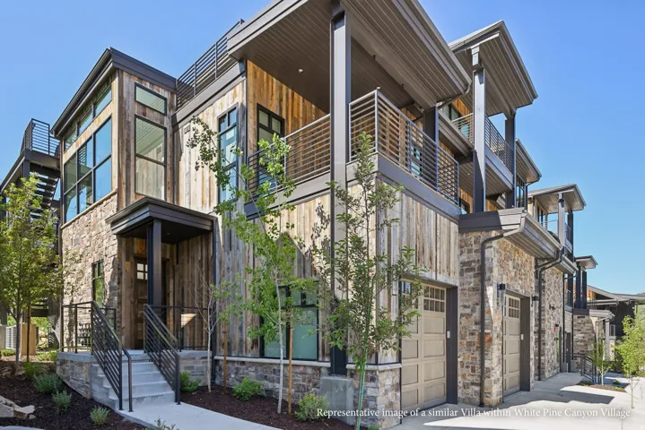 Stone and wood-clad exterior with multiple balconies and integrated garages