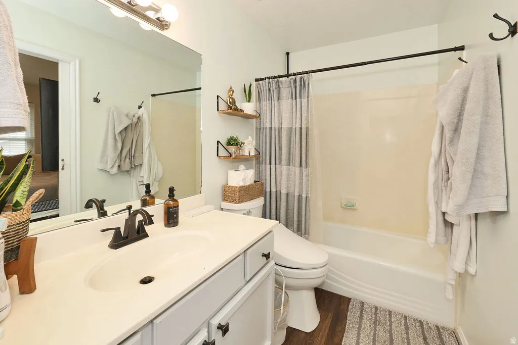 Bathroom featuring a single vanity with an integrated sink, dark bronze-finish fixtures, and light gray cabinetry