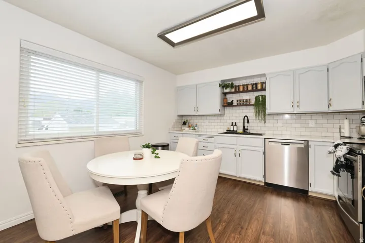 Kitchen featuring light-toned cabinetry, subway tile backsplash, and stainless steel appliances