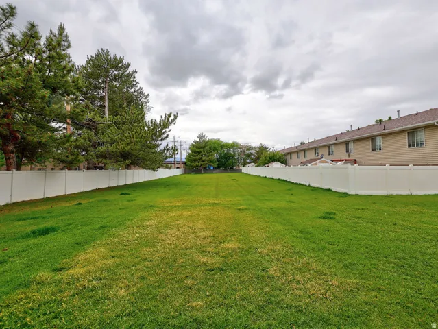 Expansive green space featuring a level lawn