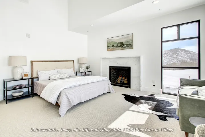 Spacious room featuring a central fireplace with a light-toned stone surround and herringbone-patterned firebox