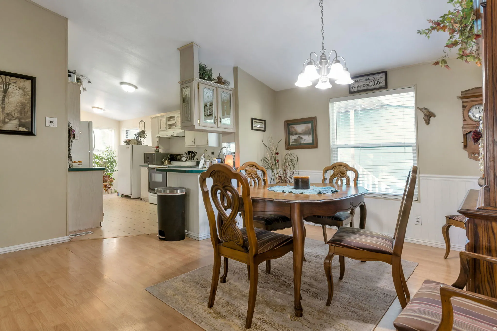 Dining area featuring wood-finish flooring and a contemporary chandelier