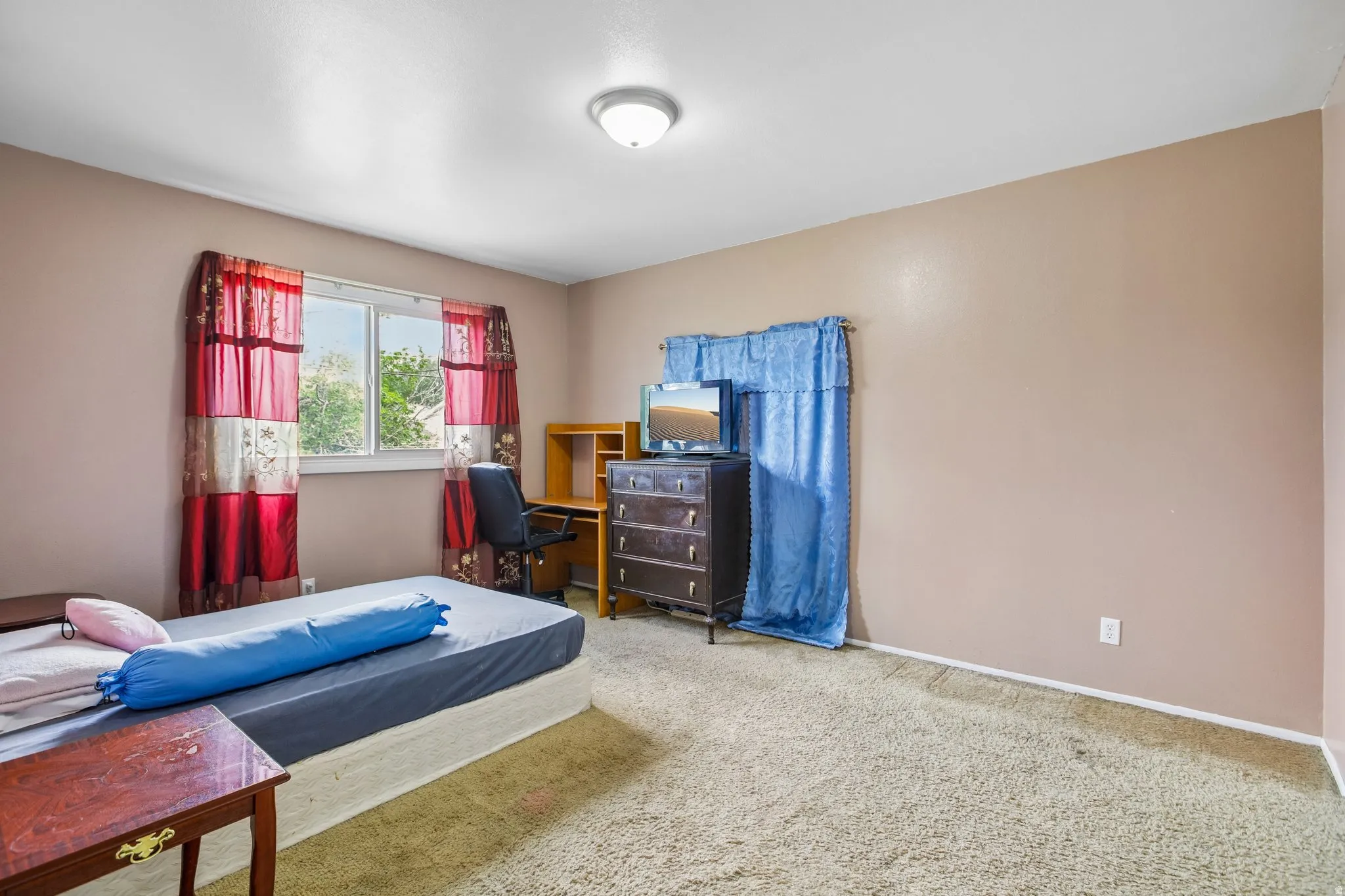 Room with neutral wall paint and light-colored carpet flooring