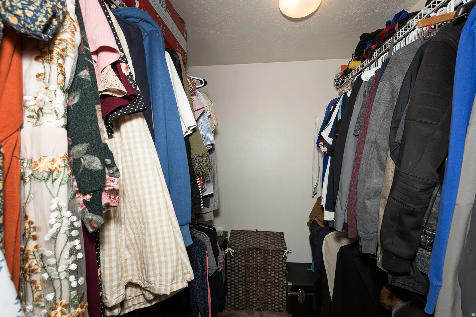 Walk-in closet featuring white walls, a ceiling-mounted light fixture, and wire shelving with hanging rods