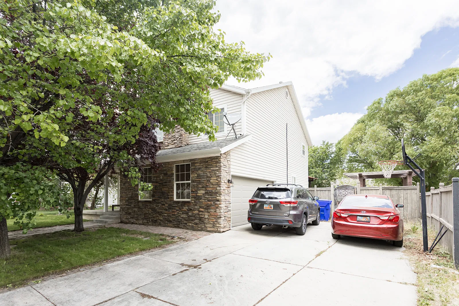 Stone facade detailing a multi-level residence with a side-entry garage