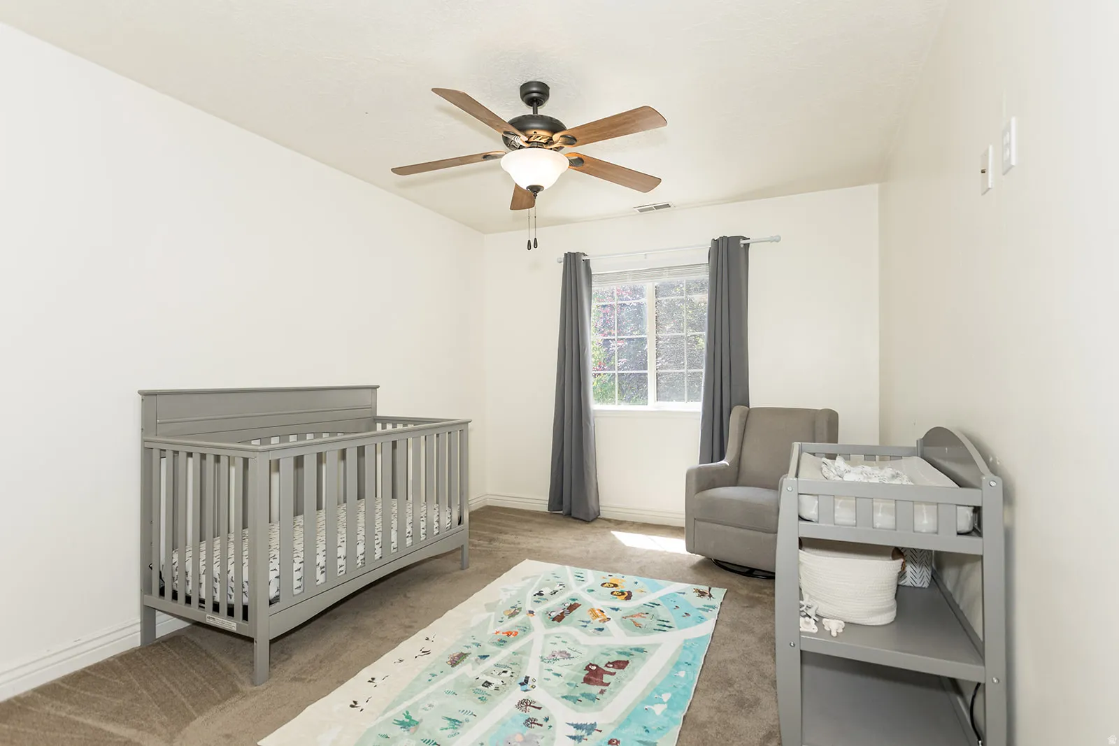 Carpeted room with a ceiling fan, recessed window, and neutral wall tones
