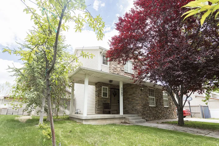 Two-story residence featuring stone veneer and horizontal siding