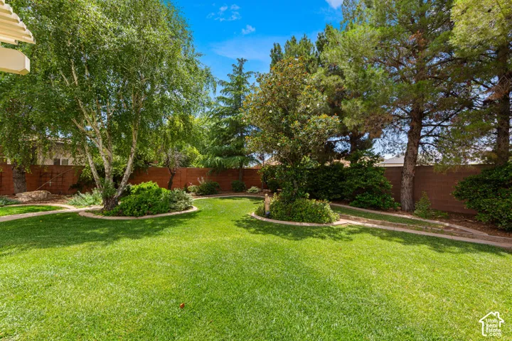 Expansive lawn area featuring mature trees and established landscaping
