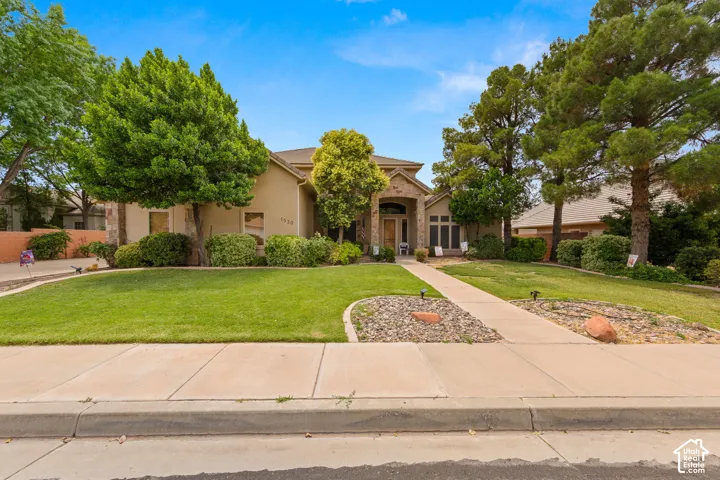 Stucco exterior with stone accents and an arched entry