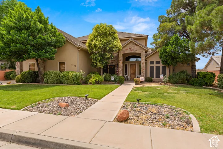 Stucco exterior with stone accents, featuring a prominent arched entry
