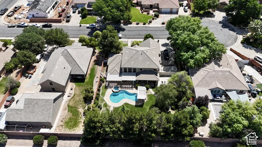 Expansive property featuring a private swimming pool, mature perimeter landscaping, and a covered patio