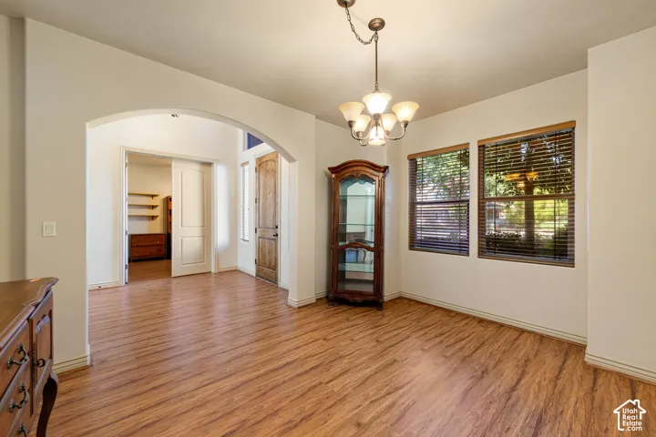 Spacious room with wood-finish flooring and a neutral color palette
