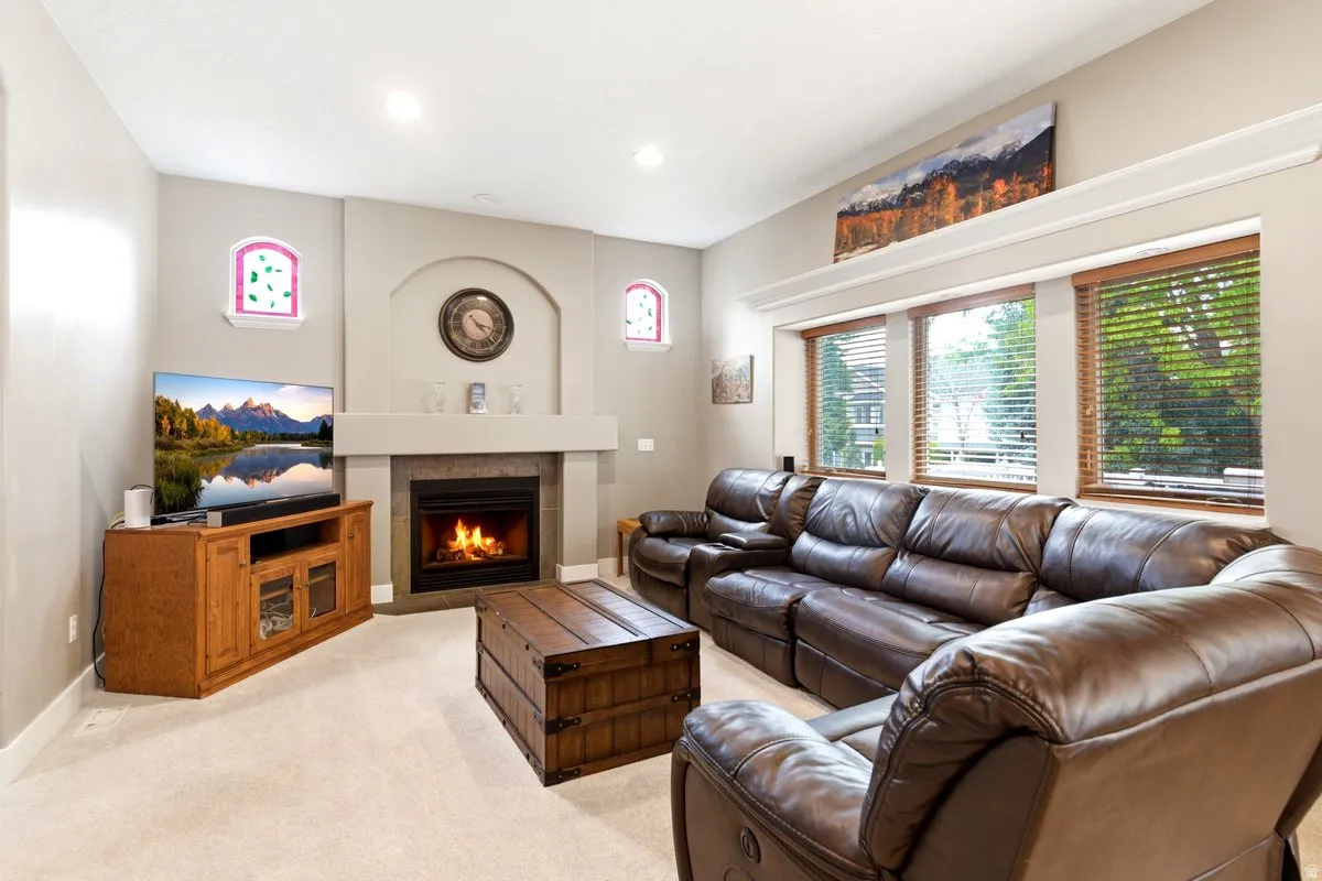 Living area featuring a gas fireplace with a stone surround, a mantelpiece, and an arched niche