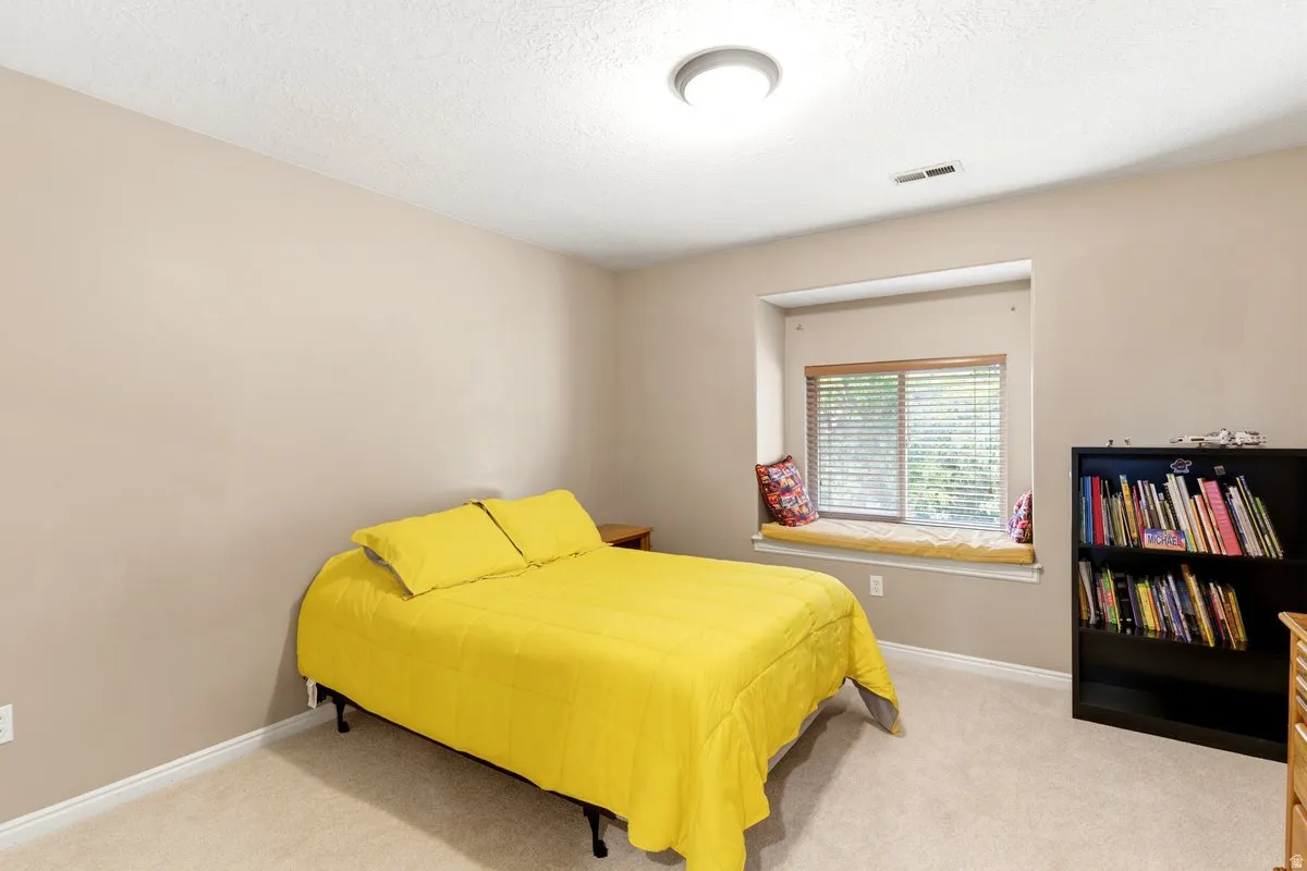 Carpeted room with a recessed window seat, neutral wall color, and a flush mount ceiling light