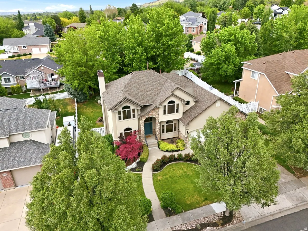 Traditional-style residence with a prominent chimney and arched entryway