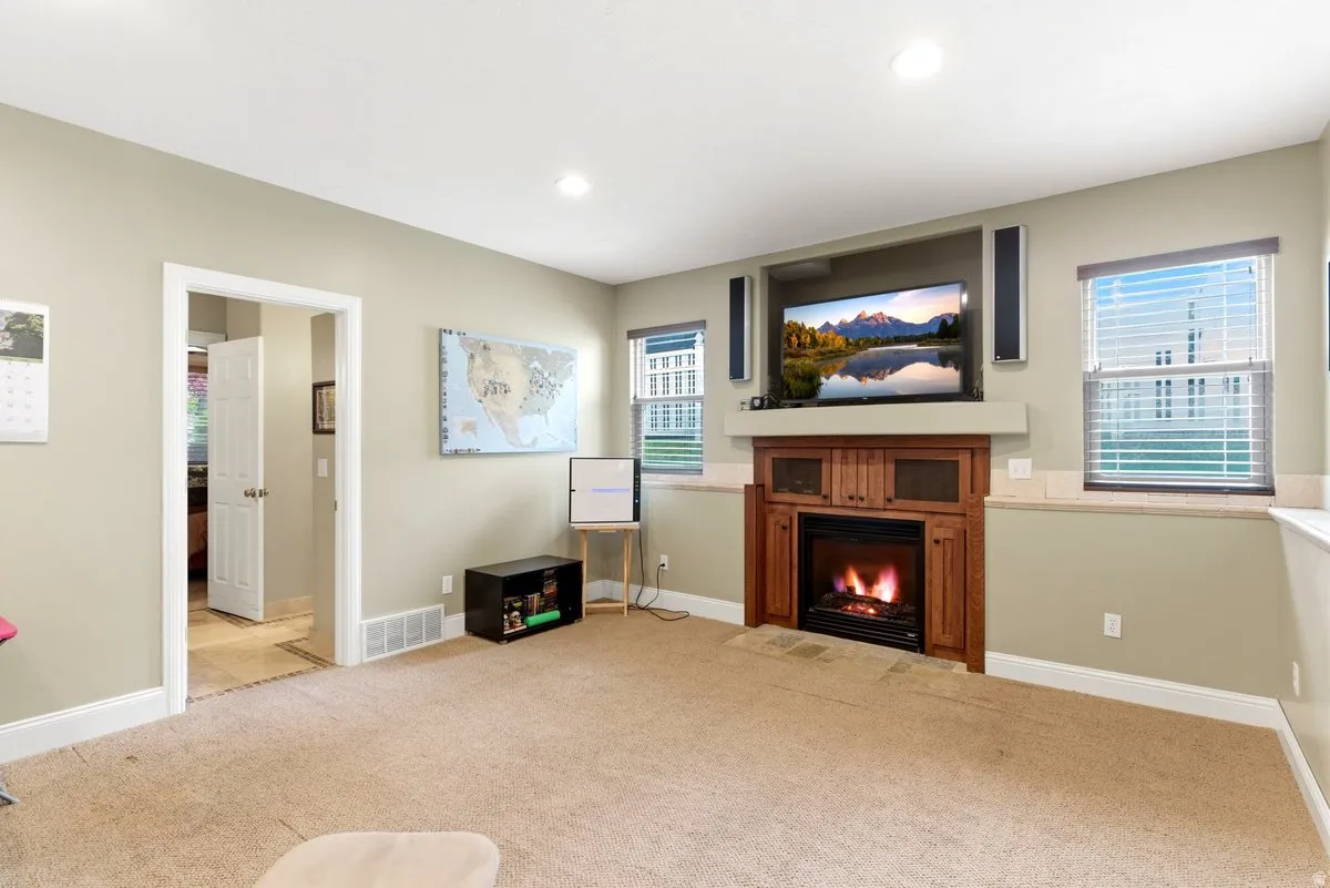 Built-in media center featuring a fireplace with a wood surround and hearth