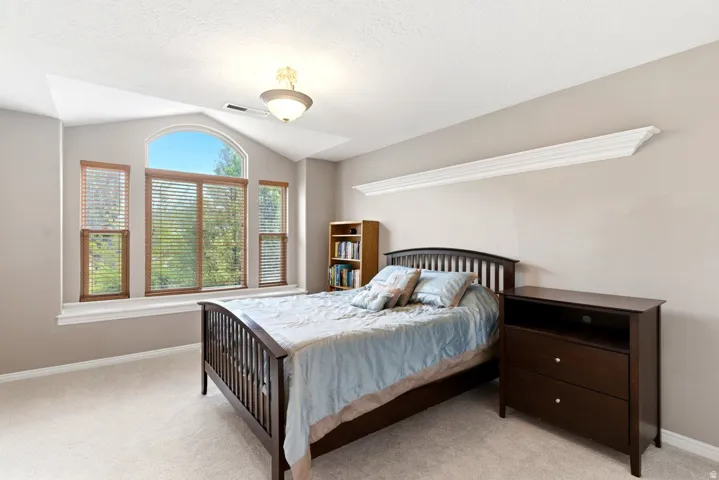 Arched and rectangular windows with wood blinds, providing exterior views