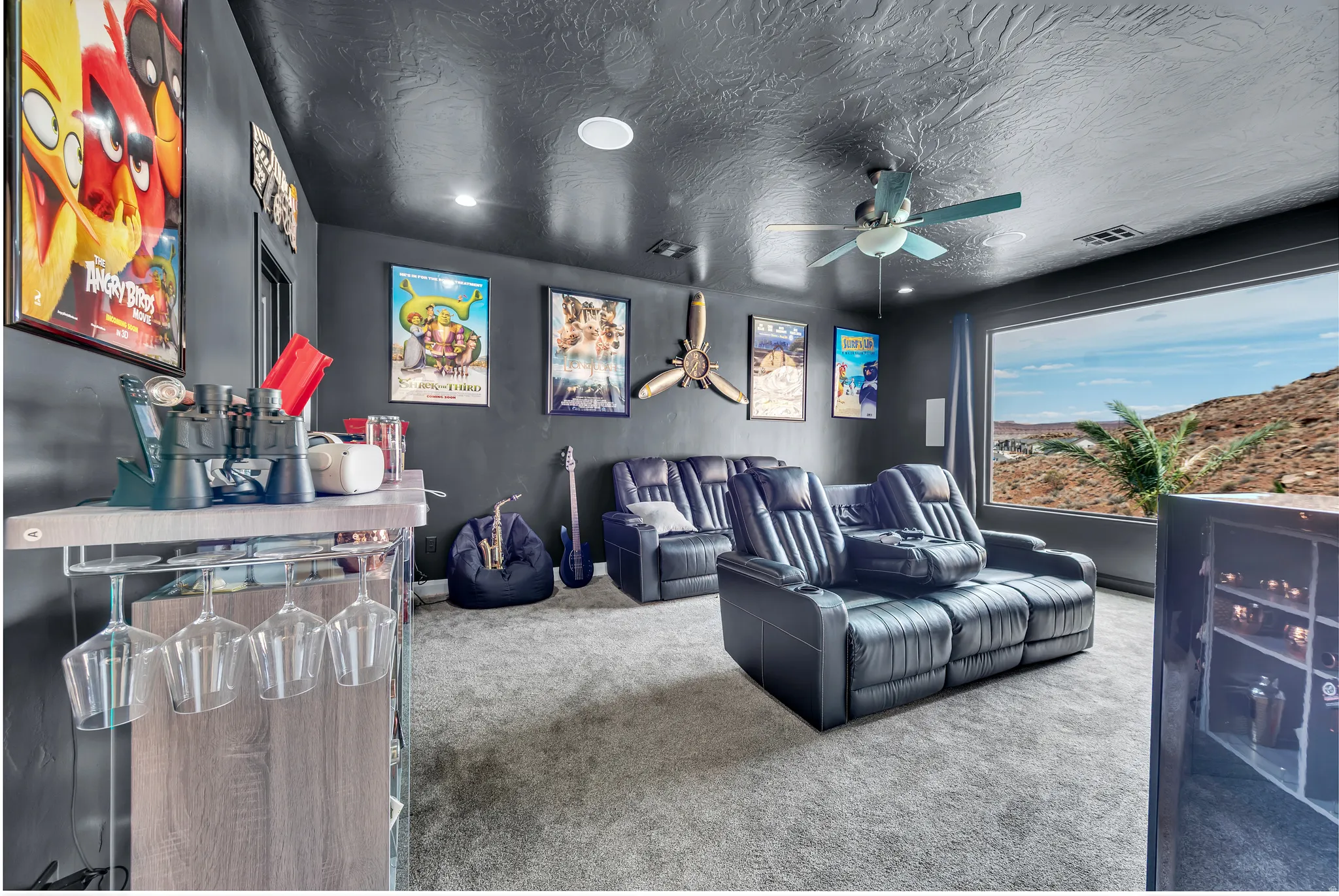 Dedicated media room featuring recessed lighting, a ceiling fan, a large picture window, and light gray carpeting