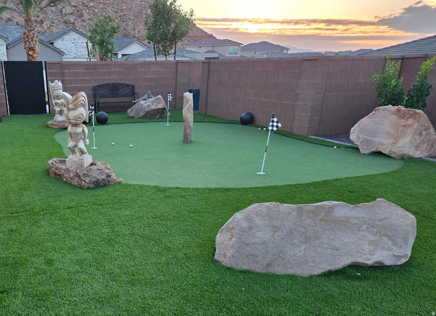 Backyard putting green surrounded by artificial turf