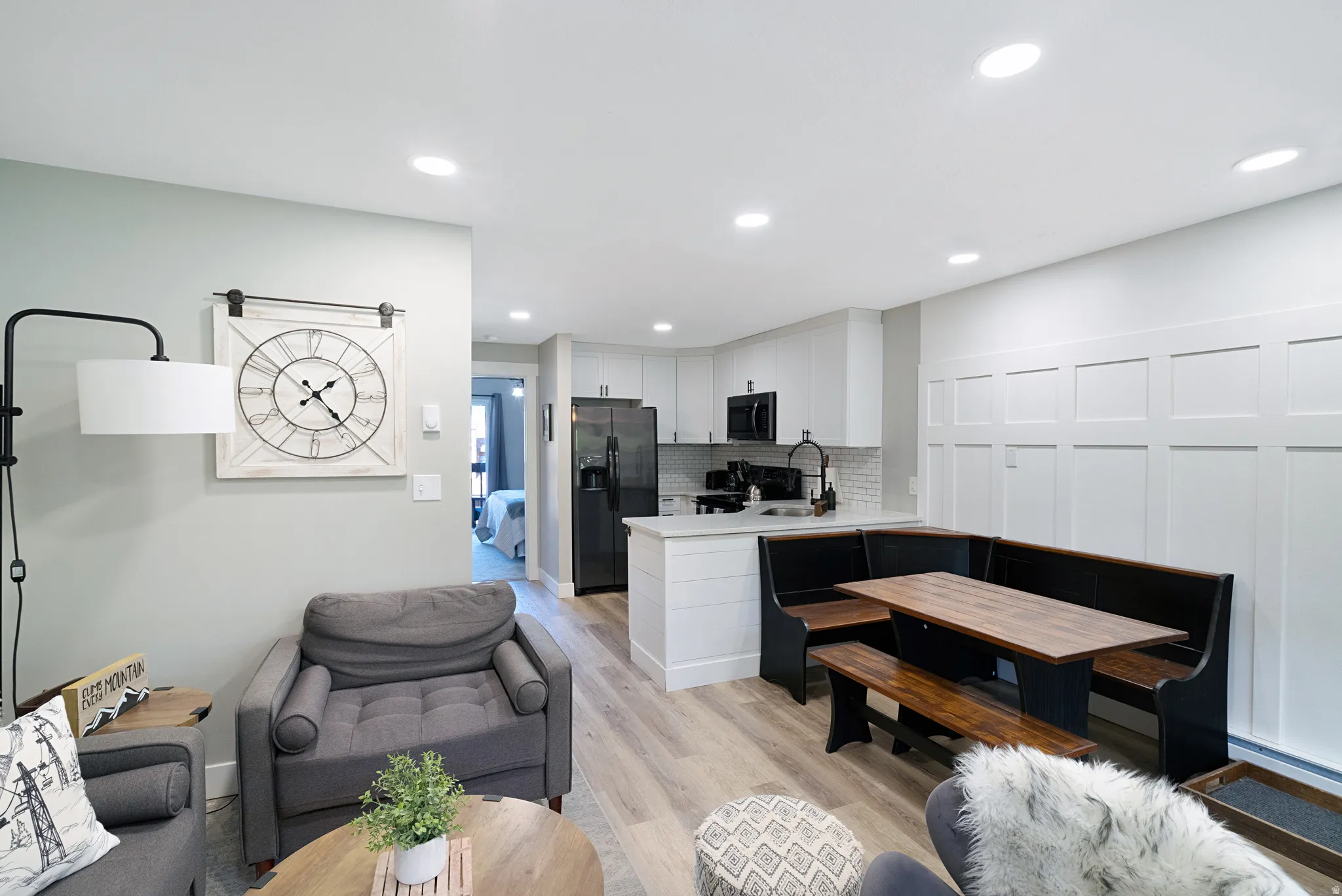 Open-concept living area with recessed lighting and light wood-finish flooring