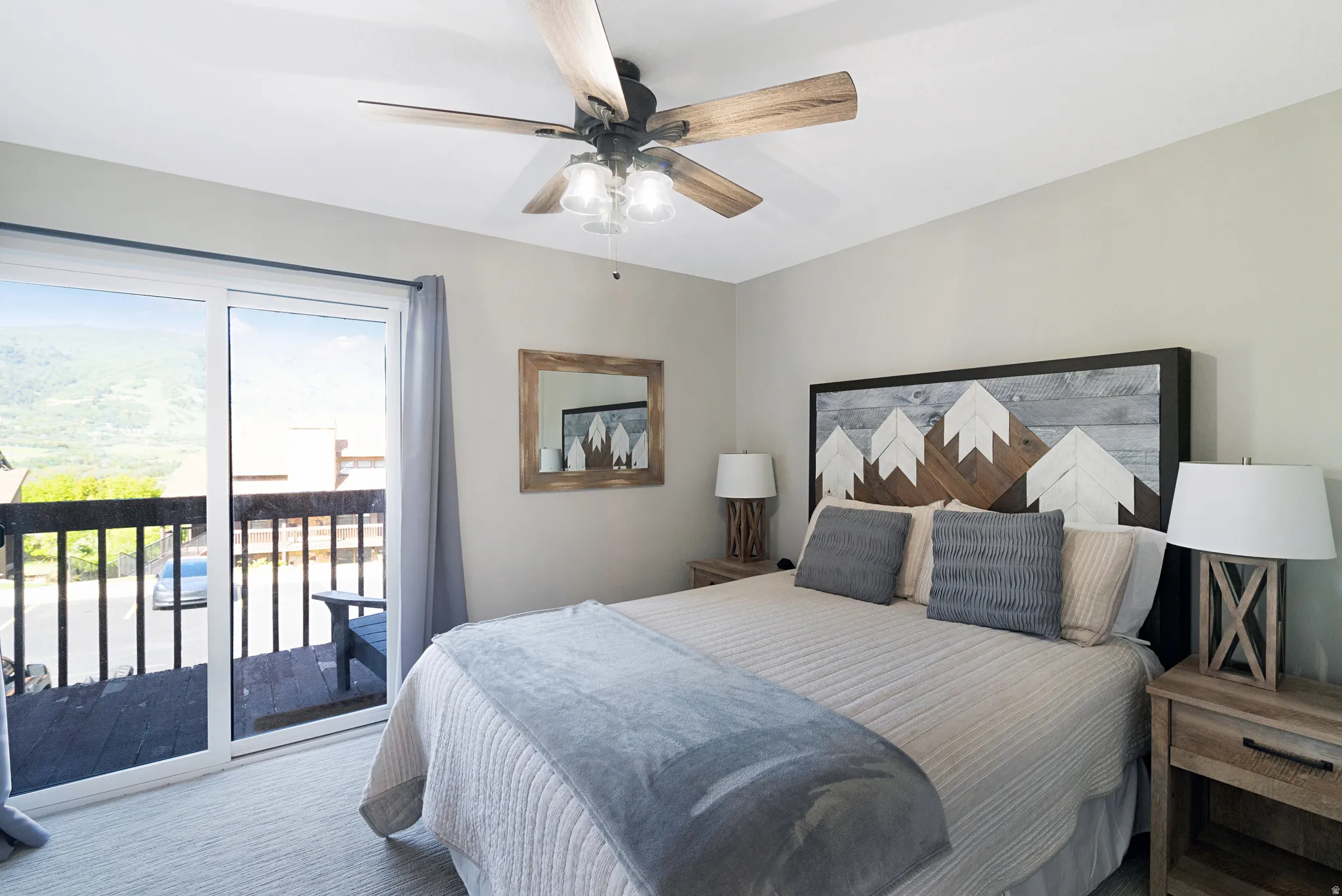 Room featuring a sliding glass door opening to an outdoor deck with wood railing