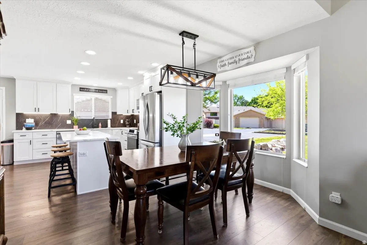 Dining area featuring wood-finish flooring and a bay window