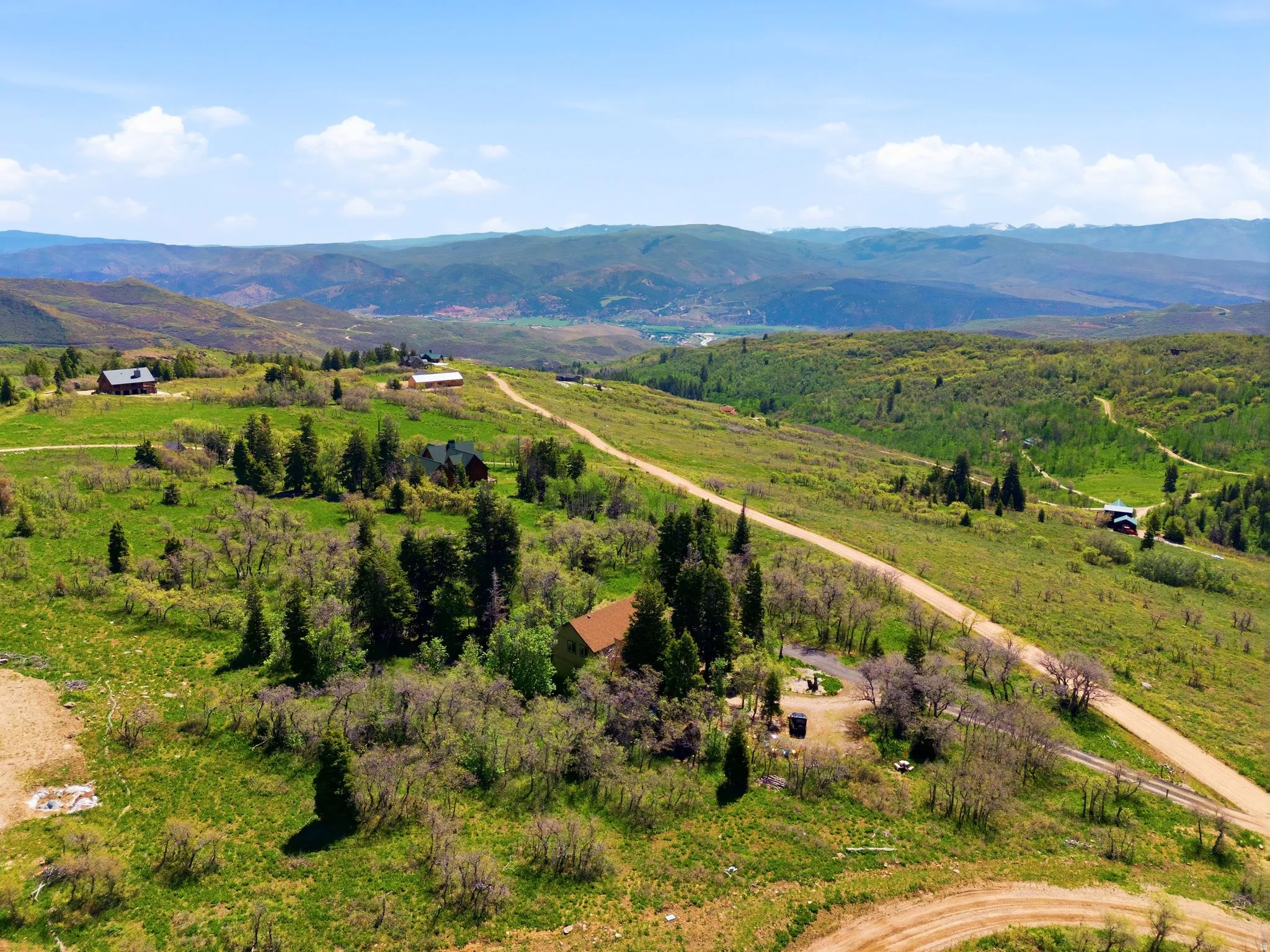 Expansive rural landscape featuring rolling hills and distant mountains