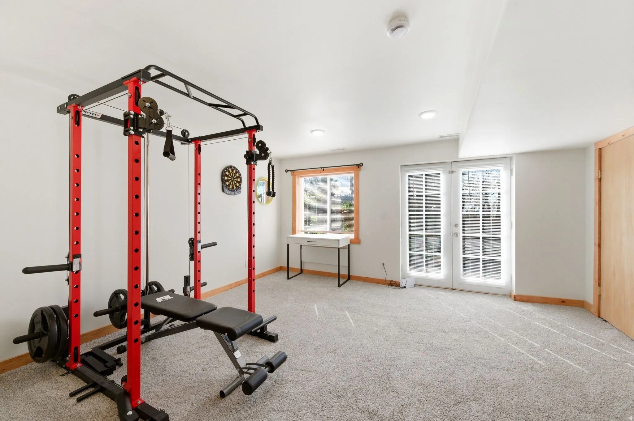 Versatile bonus room featuring light gray carpet flooring, white walls, and recessed lighting