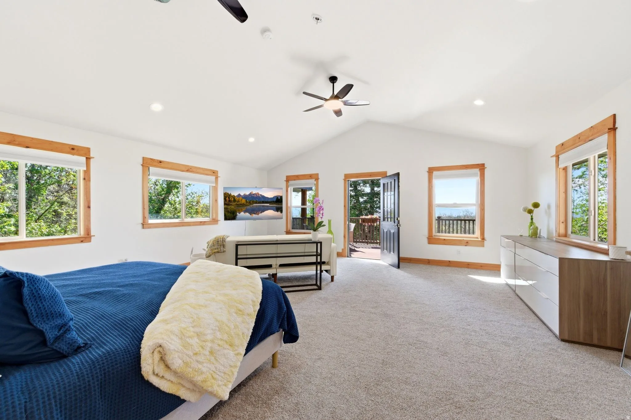 Vaulted ceiling room featuring light-colored carpet flooring, recessed lighting, and a ceiling fan