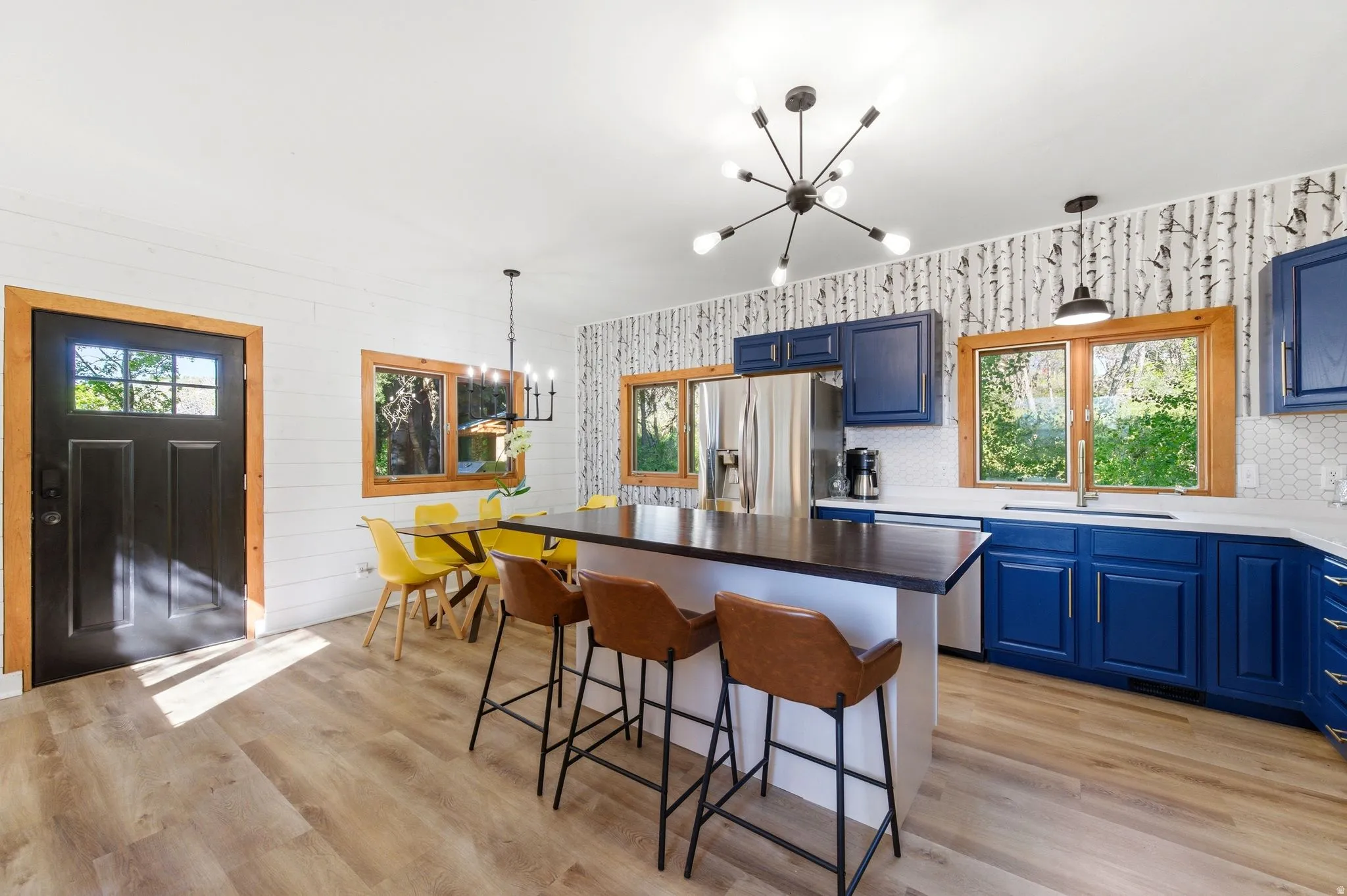 Contemporary kitchen with a central island featuring a dark countertop and seating