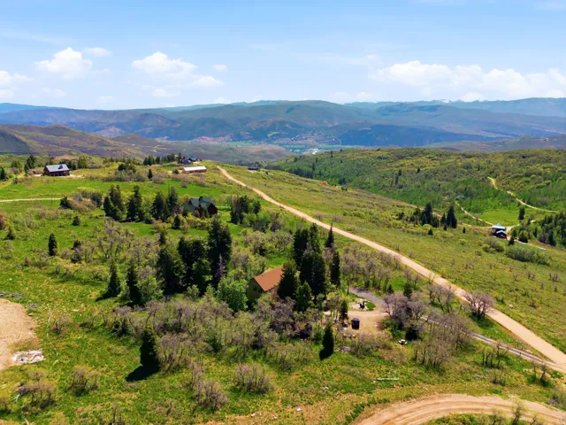 Expansive rural landscape featuring rolling hills and distant mountains