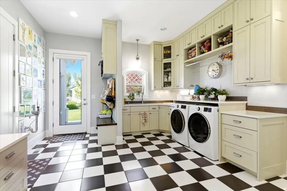 Utility room featuring checkerboard tile flooring, extensive cabinetry, a built-in bench with storage, a countertop workspace, and a glass-paneled exterior door