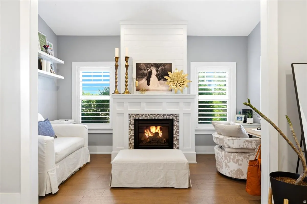 Living area featuring a central fireplace with mosaic tile surround and shiplap detailing