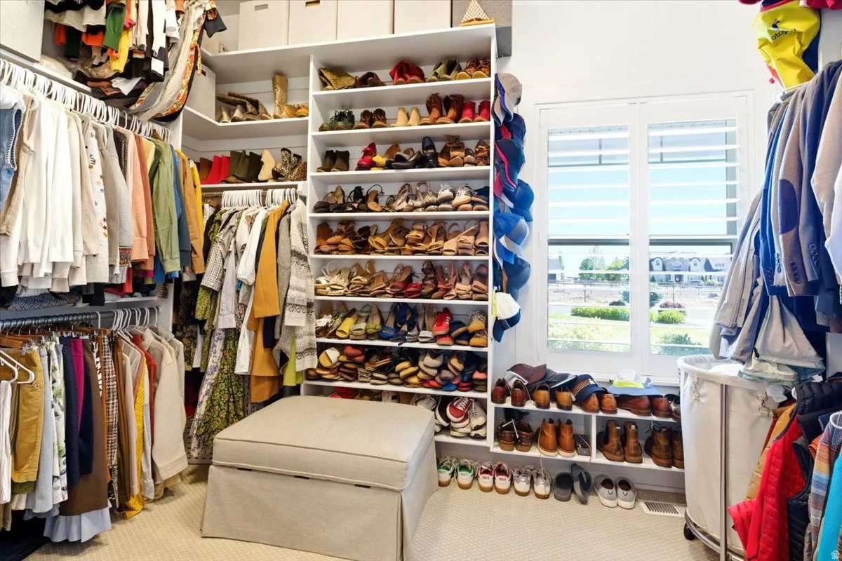 Custom closet system featuring extensive shelving and hanging rods