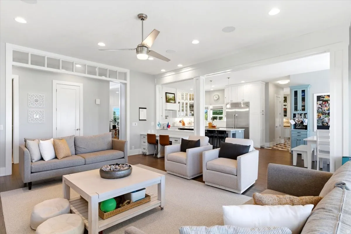 Expansive open-concept living space featuring wood-finish flooring and recessed lighting