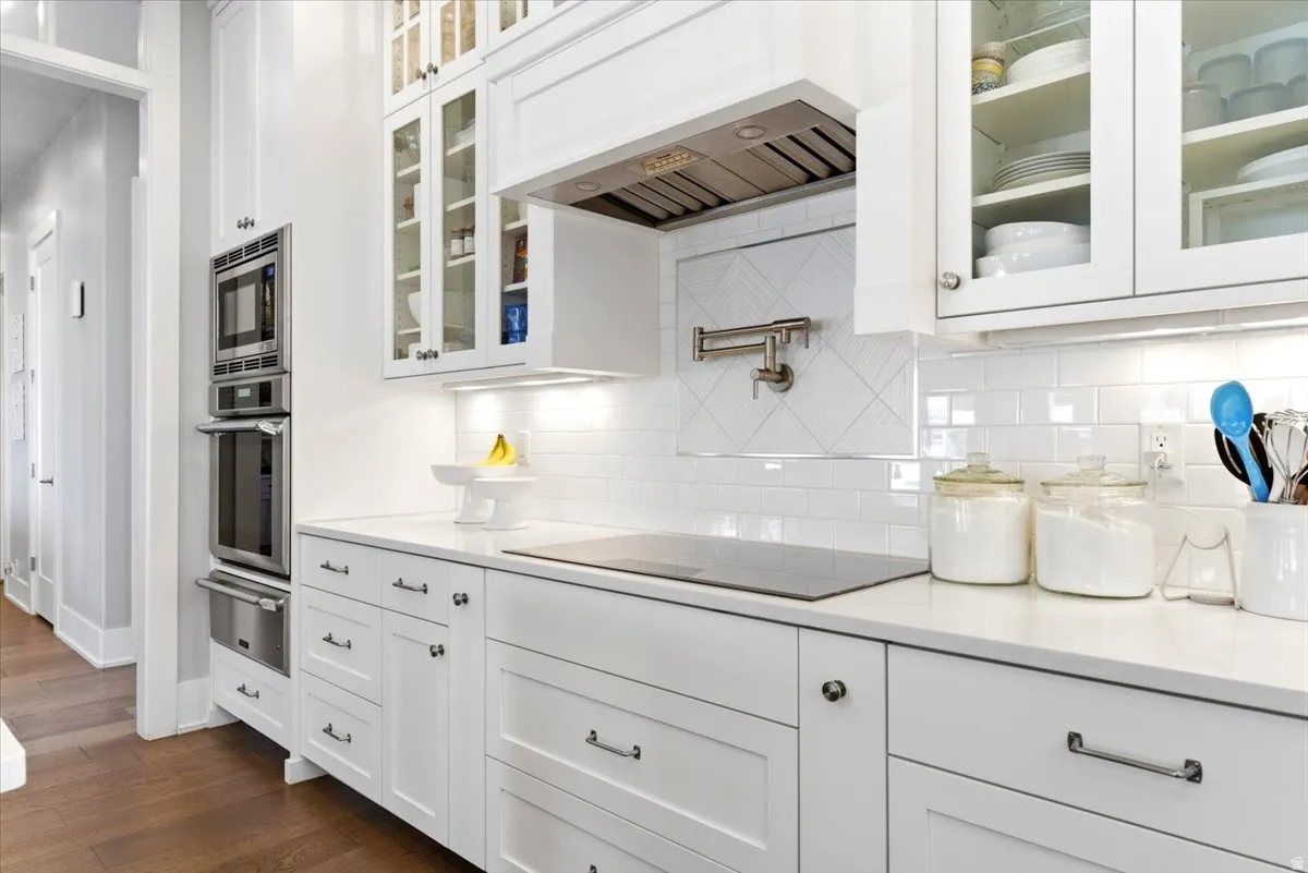 Modern kitchen featuring white cabinetry and light countertops